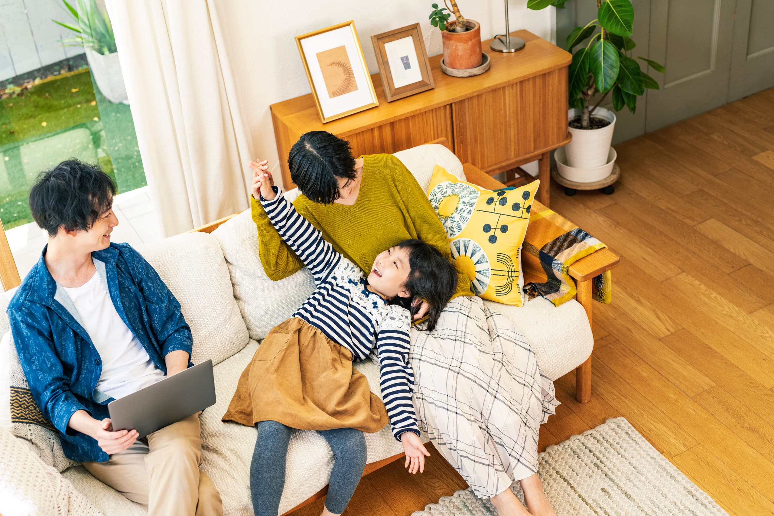 家のリビングで団欒する家族